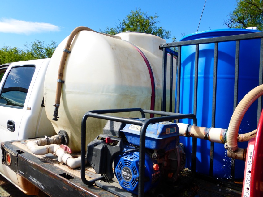 Joel's gear that includes spare water barrels, water, food and more