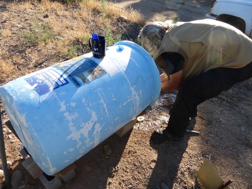 Joel tests the water quality before he refills each water tank